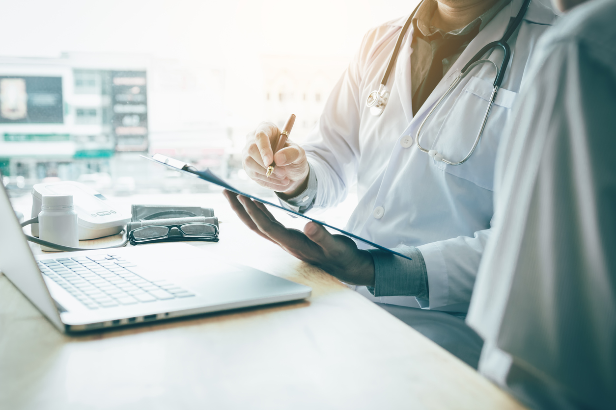 Doctor hand holding pen writing patient history list