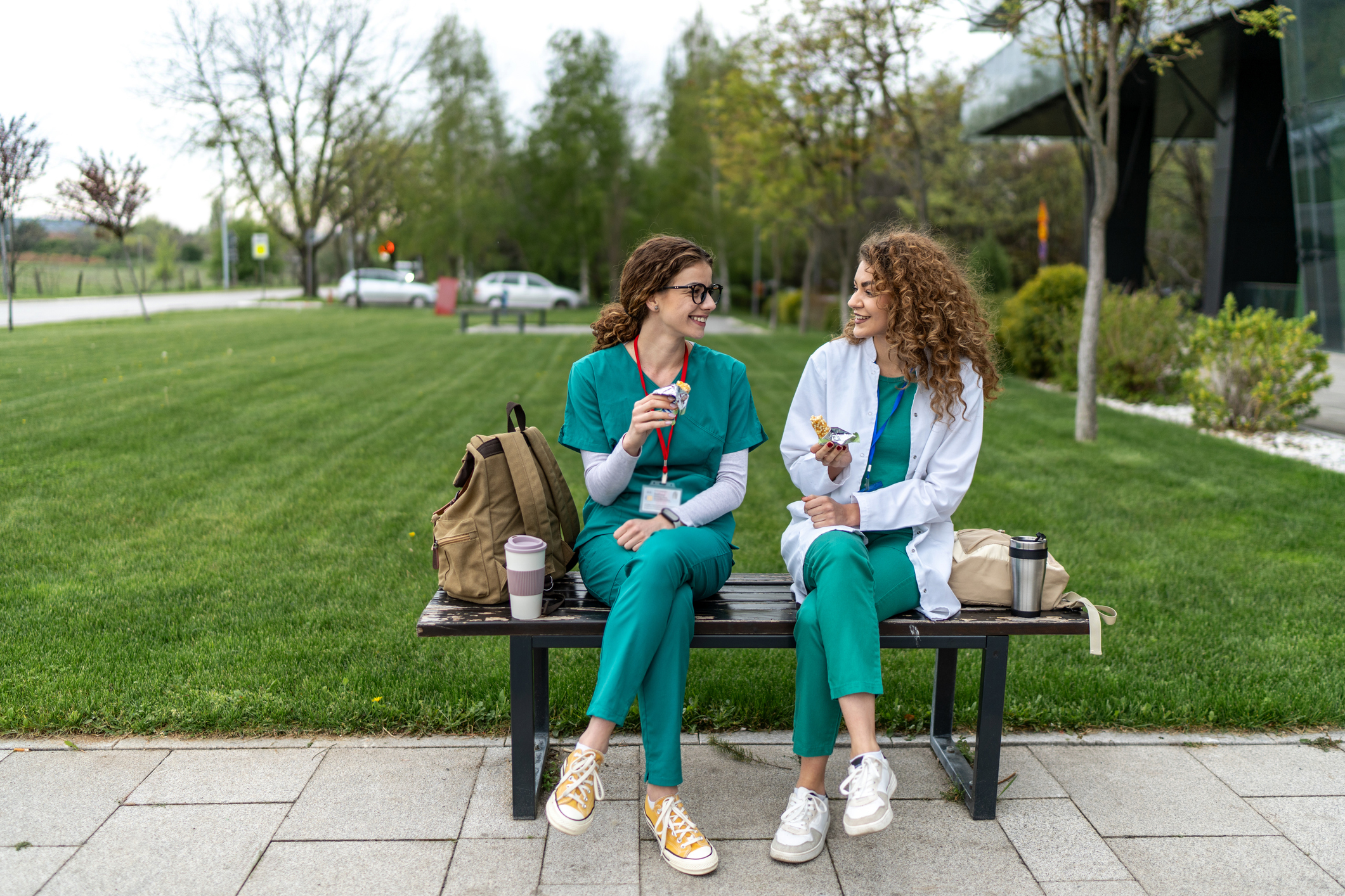 Two doctors sitting outside in the warm weather